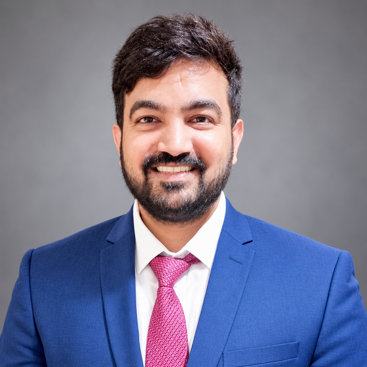 Jigarkumar Shah in a blue suit and pink tie